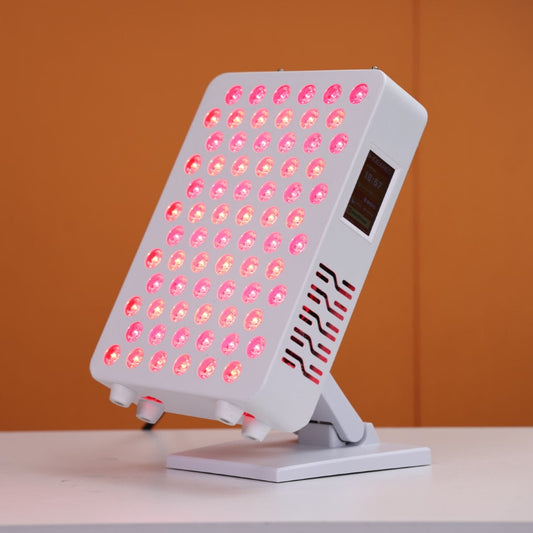 Angled view of the Nicebeam Red Light Therapy Panel Master, featuring 72 glowing LED dual chips emitting therapeutic red and near-infrared light. The panel includes a touch-screen control interface on the side for easy customization and is mounted on a stable, adjustable stand. Set against a vibrant orange background, the design highlights its sleek and modern aesthetic.